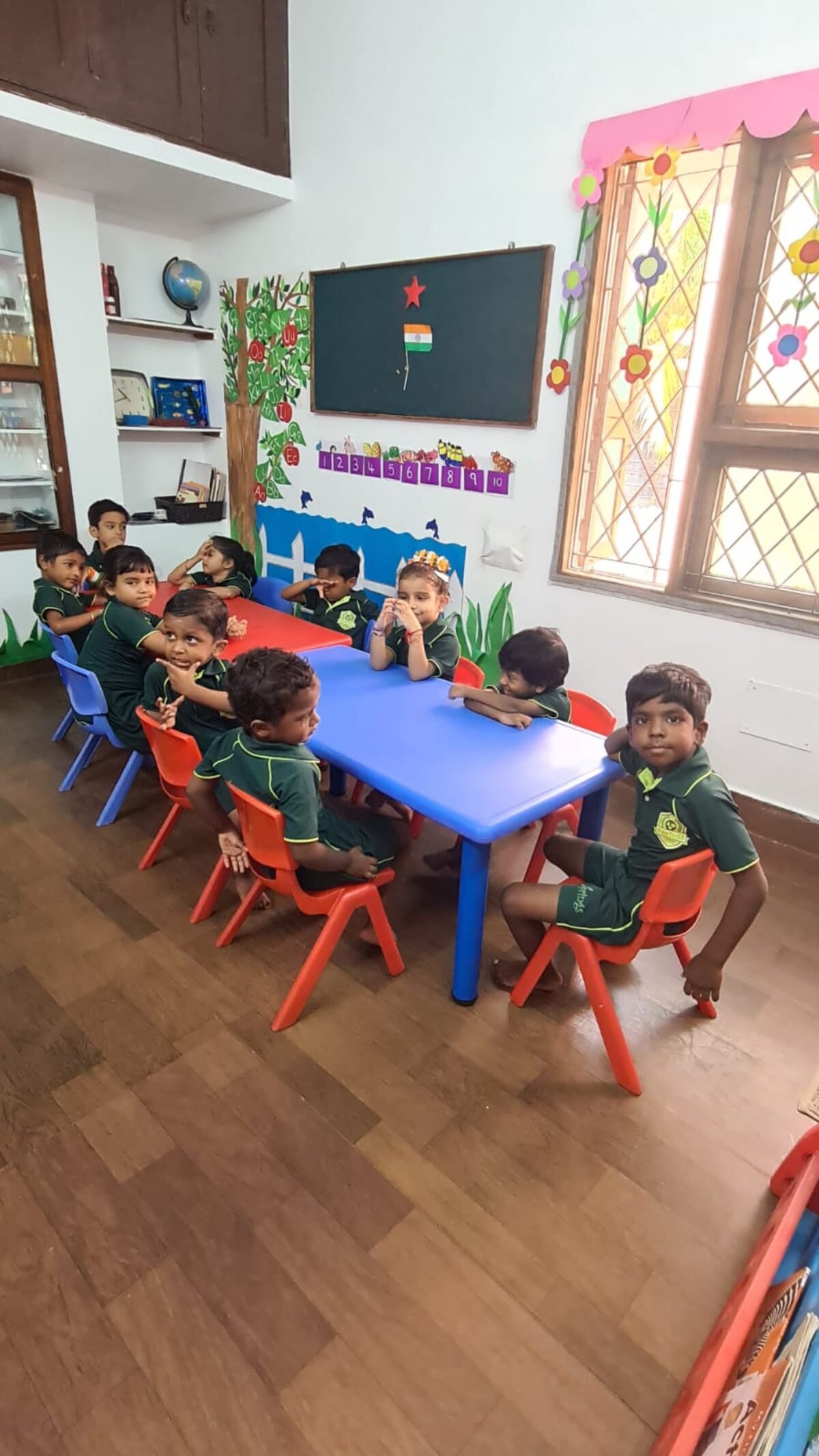 Children seated together during circle time in a bright classroom